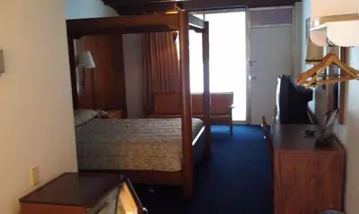 a bedroom with a bunk bed with a desk and a bed sidx sidx sidx at Kings Inn Cleveland in Strongsville