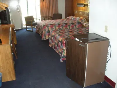 a hotel room with a bed and a television at Kings Inn Cleveland in Strongsville