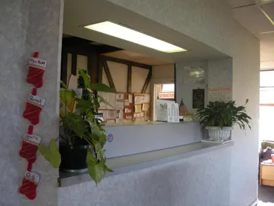 a reflection of a counter in a room with plants at Kings Inn Cleveland in Strongsville