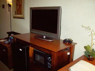 a television on top of a wooden table at Hampton Inn Sidney in Sidney