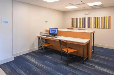 an office with a desk with a computer on it at Holiday Inn Express Hotel & Suites Richwood - Cincinnati South by IHG in Richwood