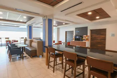 a dining room with a table and chairs at Holiday Inn Express Hotel & Suites Richwood - Cincinnati South by IHG in Richwood