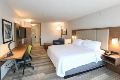 a hotel room with a large bed and a desk at Holiday Inn Express Hotel & Suites Richwood - Cincinnati South by IHG in Richwood