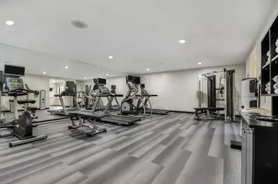 a gym with several exercise bikes and treadmills at Staybridge Suites Toledo/Maumee by IHG in Maumee