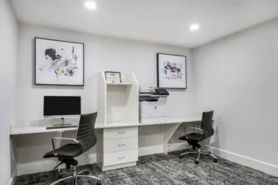 an office with a desk with two chairs and a computer at Staybridge Suites Toledo/Maumee by IHG in Maumee