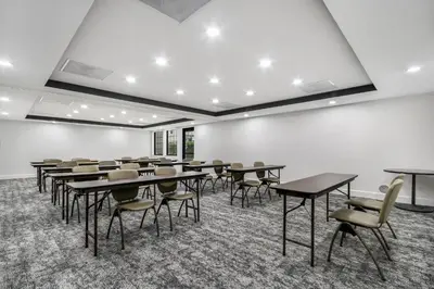 a classroom with tables and chairs in a room at Staybridge Suites Toledo/Maumee by IHG in Maumee