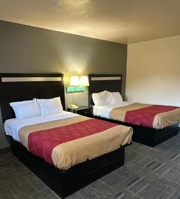 a hotel room with two beds in a room at Budget Host Inn Charleston in Charleston