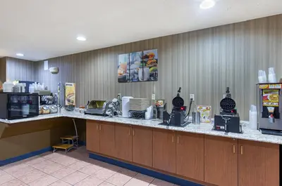a kitchen with a long counter with a microwave at Microtel Inn & Suites by Wyndham Dry Ridge in Dry Ridge