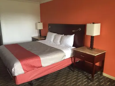 a hotel room with a bed with a red wall at Motel 6-Dayton, OH in Dayton