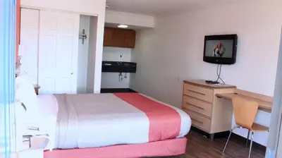 a bedroom with a bed and a desk and a television at Motel 6-Dayton, OH in Dayton