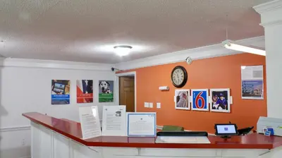 an office with a desk with a clock on the wall at Motel 6-Dayton, OH in Dayton