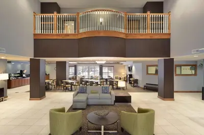 a large lobby with a living room and dining room at Wingate by Wyndham Sylvania-Toledo in Sylvania