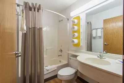 a bathroom with a sink and a toilet and a tub at Motel 6-Streetsboro, OH in Streetsboro