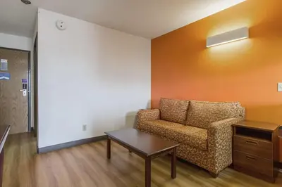 a waiting room with a couch and a table at Motel 6-Streetsboro, OH in Streetsboro