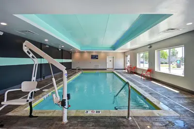 a swimming pool in a building with a ceiling at Tru By Hilton Fort Wayne in Fort Wayne