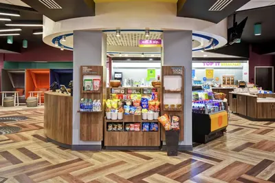 a grocery store with a store front with products at Tru By Hilton Fort Wayne in Fort Wayne