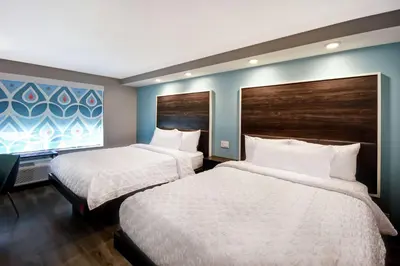 a hotel room with two beds and a window at Tru By Hilton Fort Wayne in Fort Wayne