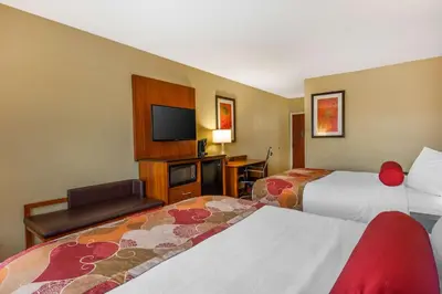 a hotel room with two beds and a flat screen tv at Best Western Plus Georgetown Corporate Center Hotel in Georgetown