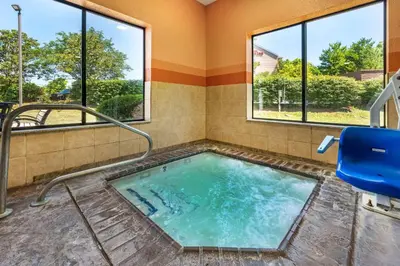 a hot tub in a room with windows at Best Western Plus Georgetown Corporate Center Hotel in Georgetown