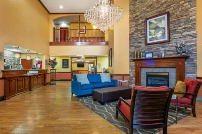 a lobby with a blue couch and a fireplace at Best Western Plus Georgetown Corporate Center Hotel in Georgetown