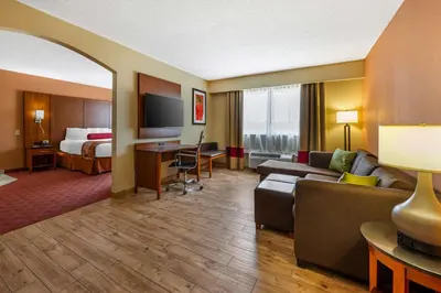 a hotel room with a couch and a bed at Best Western Plus Georgetown Corporate Center Hotel in Georgetown