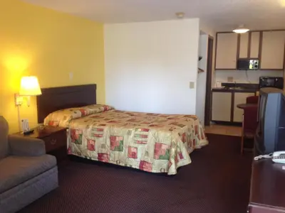 a hotel room with a bed and a couch at Guest Inn Lebanon (Ohio) in Lebanon