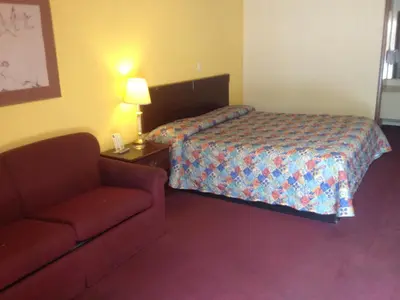 a hotel room with a bed and a couch at Guest Inn Lebanon (Ohio) in Lebanon