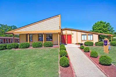 a house with a red door in a yard at Guest Inn Lebanon (Ohio) in Lebanon