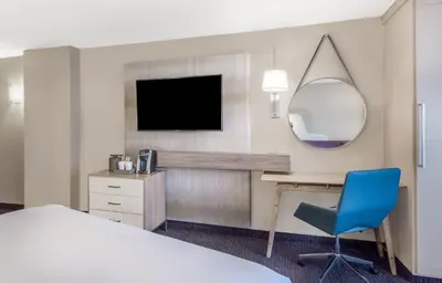 a hotel room with a desk and a tv at Crowne Plaza Cleveland at Playhouse Square by IHG in Cleveland