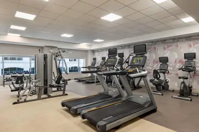 a gym with several treadmills and elliptical machines at Crowne Plaza Cleveland at Playhouse Square by IHG in Cleveland