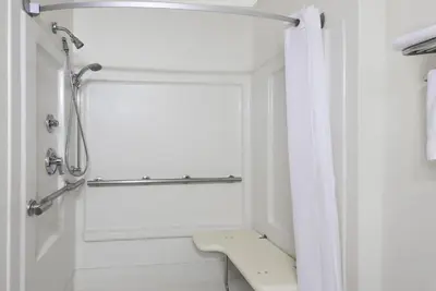 a white bathroom with a shower and a toilet at Super 8 by Wyndham Kent/Akron Area in Kent