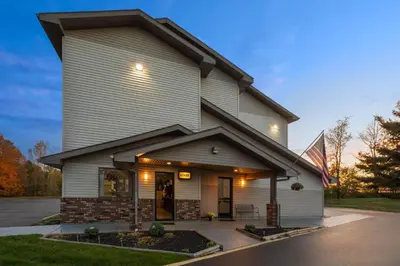 a house with a flag in front of it at Super 8 by Wyndham Kent/Akron Area in Kent