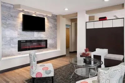 a living room with a fireplace and a flat screen tv at Baymont by Wyndham Boardman in Boardman
