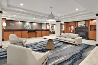 a living room with two couches and a table at Fairfield Inn & Suites by Marriott Marietta in Marietta
