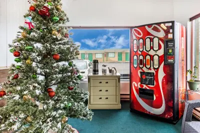 a christmas tree in a kitchen next to a refrigerator at OYO Hotel North Lima OH - Boardman in North Lima
