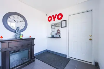 a room with a clock on the wall and a fireplace at OYO Hotel North Lima OH - Boardman in North Lima