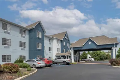 a large building with cars parked in a parking lot at Best Western Fort Wayne Inn & Suites North in Fort Wayne