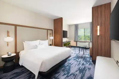 a hotel room with a bed and a desk at Fairfield Inn & Suites by Marriott Lexington East/I-75 in Lexington