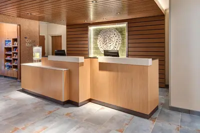a lobby with a reception desk in a building at Fairfield Inn & Suites by Marriott Lexington East/I-75 in Lexington