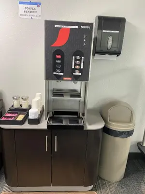 a coffee maker on a counter next to a trash can at Motel 6-Fort Wayne, IN in Fort Wayne