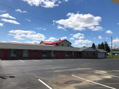 an empty parking lot in front of a building at Harcourt Motel in Mount Vernon