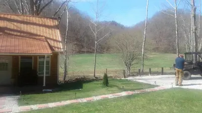 a man standing in front of a house at Tranquil Waters Cabin in Frenchburg