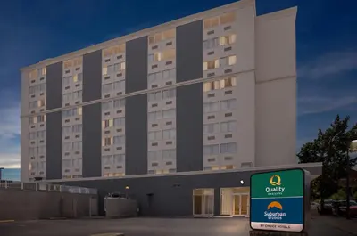 a large building with a sign in front of it at Quality Inn & Suites Charleston - Civic Center in Charleston