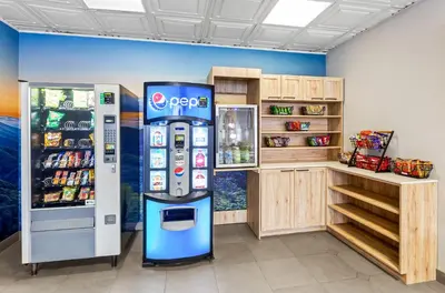 a store with a pepsi machine and a refrigerator at Quality Inn & Suites Charleston - Civic Center in Charleston