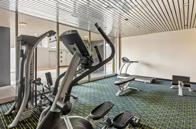 a gym with treadmills and elliptical machines at Quality Inn & Suites Charleston - Civic Center in Charleston