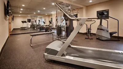 a gym with a treadmill and tread machines at Days Inn by Wyndham Englewood Dayton Airport in Dayton