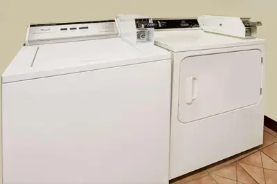 a white washer and dryer sitting next to each other at Super 8 by Wyndham Heath/Newark in Heath