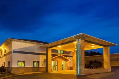 a rendering of a building at night at Super 8 by Wyndham Heath/Newark in Heath