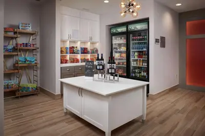a room with a counter with bottles of wine at Homewood Suites By Hilton Cincinnati Midtown in Cincinnati