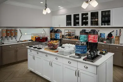 a kitchen with a large white island in a kitchen at Homewood Suites By Hilton Cincinnati Midtown in Cincinnati